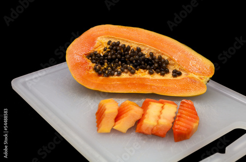 Photo: Sweet papaya isolated on black. Sweet papaya isolated on black.