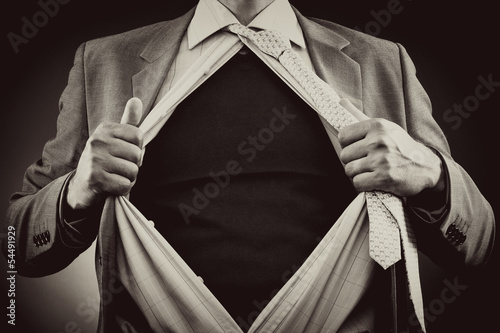Photo: Conceptual image of a man tearing off his shirt Conceptual image of a man tearing off his shirt