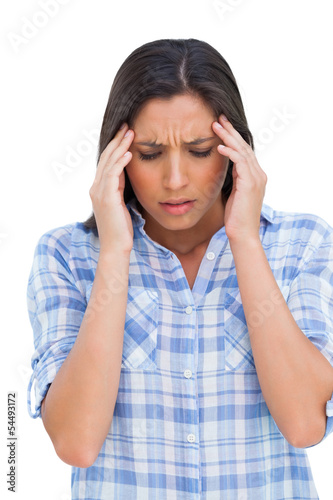 Photo: Woman with a headache rubbing her temples Woman with a headache rubbing her temples