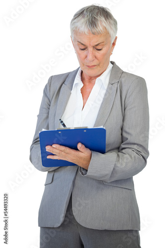 Photo: Businesswoman using her clipboard Businesswoman using her clipboard