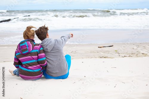 Photo: happy pair of male and female embracing and having fun wearing w happy pair of male and female embracing and having fun wearing w