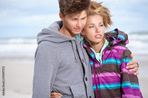 Photo: Couple embracing and having fun wearing warm clothes outside on Couple embracing and having fun wearing warm clothes outside on