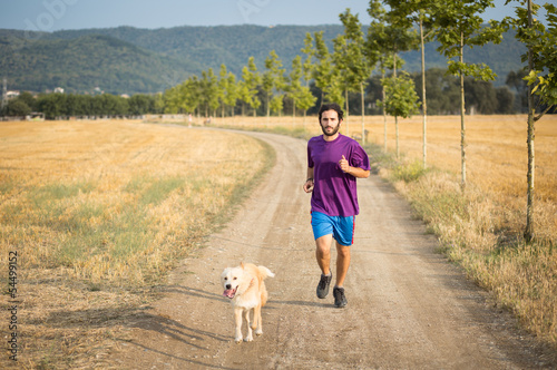 Photo: Guy running with a dog Guy running with a dog