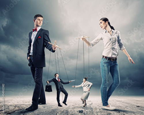 Photo: Businesspeople with marionettes Businesspeople with marionettes