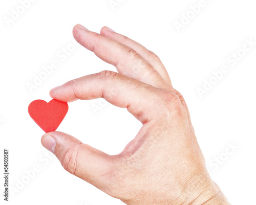 Photo: Man's hand holding a human heart. Symbol of health and love. Man's hand holding a human heart. Symbol of health and love.