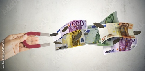 Photo: Magnet attracts money Magnet attracts money