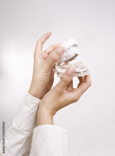 Photo: Dental Casting - hands holding dental gypsum models, dental conc Dental Casting - hands holding dental gypsum models, dental conc