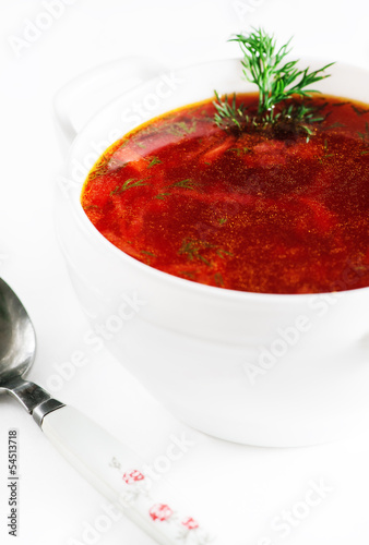 Photo: Red beetroot soup on white background Red beetroot soup on white background
