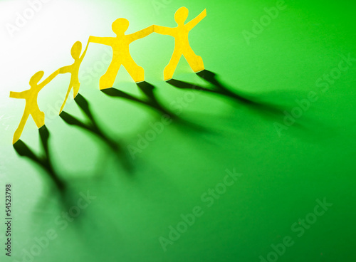 Photo: Paper people in teamworking concept Paper people in teamworking concept