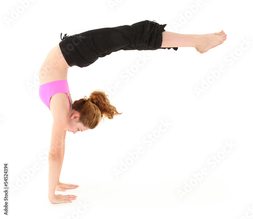 Photo: Beautiful strong child in a handstand with legs held out. Clippi Beautiful strong child in a handstand with legs held out. Clippi