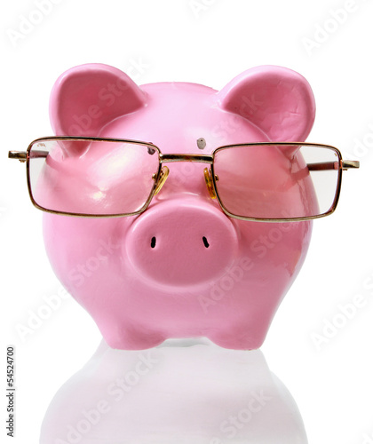 Photo: piggy bank with glasses in isolated white background piggy bank with glasses in isolated white background