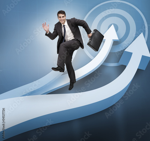 Photo: Businessman jumping over blue arrows Businessman jumping over blue arrows