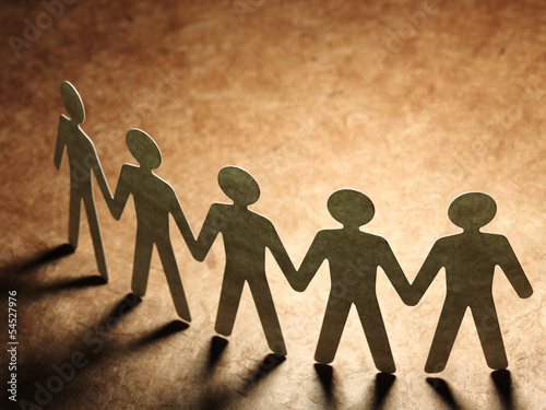 Photo: Group of paper people holding hands. Group of paper people holding hands.