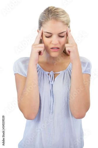 Photo: Unsmiling young woman has a headache Unsmiling young woman has a headache