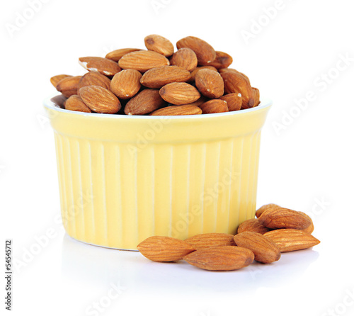 Photo: Almond in bowl, isolated on white Almond in bowl, isolated on white
