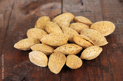 Photo: Almond on dark wooden background Almond on dark wooden background