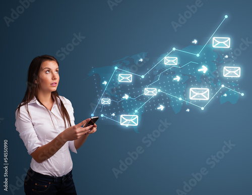 Photo: Young lady holding a phone with arrows and message icons Young lady holding a phone with arrows and message icons
