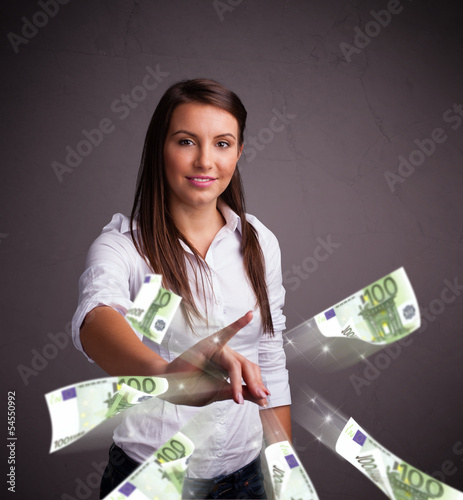 Photo: Pretty woman standing and throwing money Pretty woman standing and throwing money