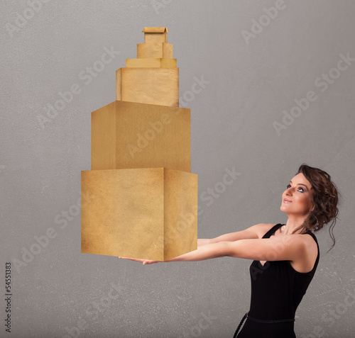 Photo: Young lady holding a set of brown cardboard boxes Young lady holding a set of brown cardboard boxes