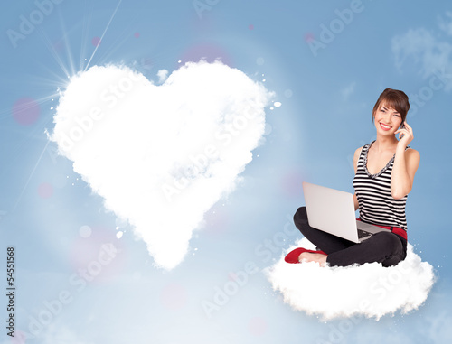 Photo: Beautiful lovely woman sitting on cloud with heart Beautiful lovely woman sitting on cloud with heart