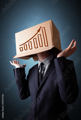 Photo: Businessman gesturing with a cardboard box on his head with diag Businessman gesturing with a cardboard box on his head with diag