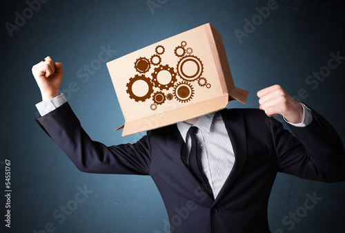 Photo: Businessman gesturing with a cardboard box on his head with spur Businessman gesturing with a cardboard box on his head with spur