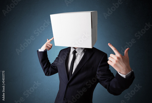 Photo: Businessman gesturing with a cardboard box on his head Businessman gesturing with a cardboard box on his head