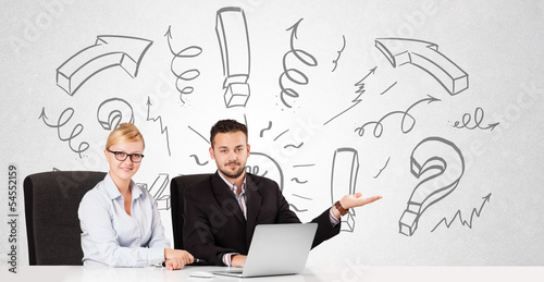 Photo: Businessman and businesswoman brainstorming with drawn arrows an Businessman and businesswoman brainstorming with drawn arrows an