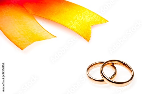Photo: gold wedding rings near ribbon with space for text gold wedding rings near ribbon with space for text