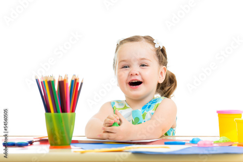 Photo: smiling child drawing and making by hands smiling child drawing and making by hands