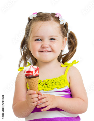 Photo: happy kid girl eating ice cream in studio isolated happy kid girl eating ice cream in studio isolated