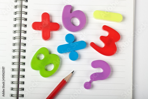 Photo: Symbols of numbers and mathematical signs on a notepad Symbols of numbers and mathematical signs on a notepad