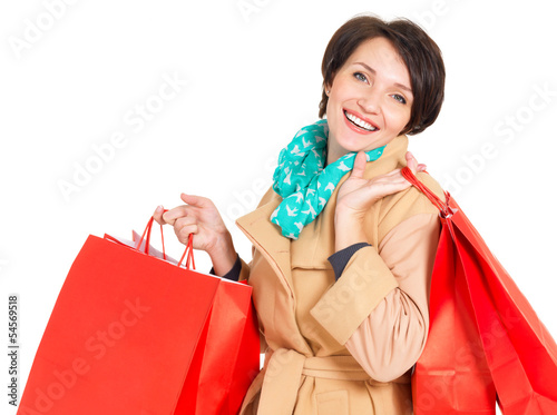 Photo: Happy woman with shopping bags in beige autumn coat Happy woman with shopping bags in beige autumn coat