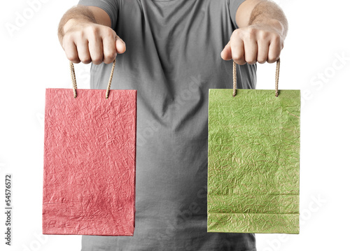 Photo: man holding two shopping bags isolated on white background. choi man holding two shopping bags isolated on white background. choi
