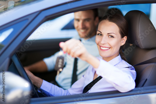 Photo: Woman Showing off New Car Keys Woman Showing off New Car Keys