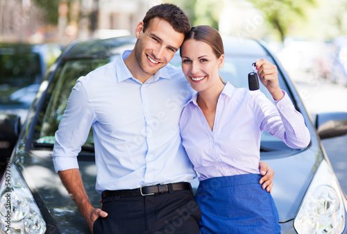 Photo: Young couple with keys to new car Young couple with keys to new car
