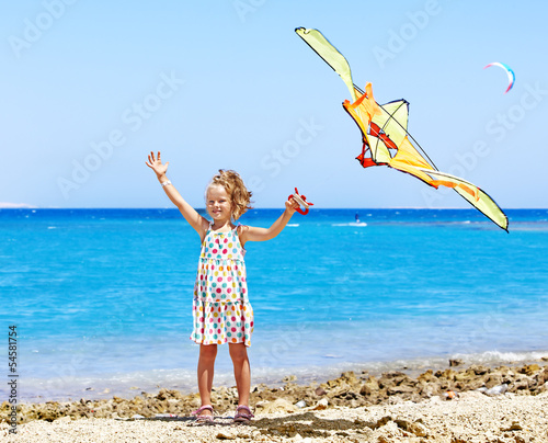 Photo: Kid flying kite outdoor. Kid flying kite outdoor.