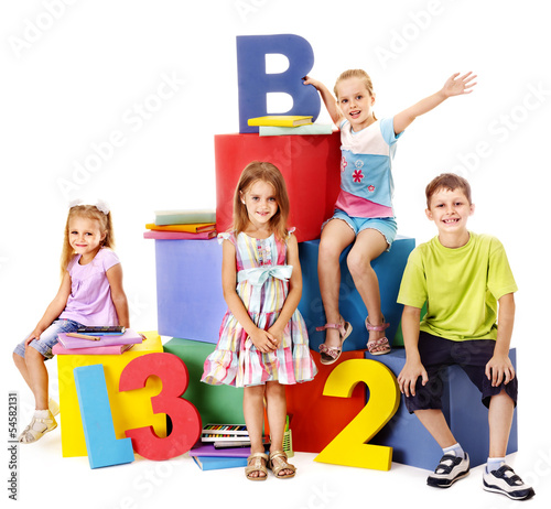 Photo: Children sitting at cube. Children sitting at cube.