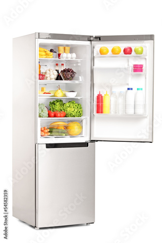 Photo: Studio shot of an open fridge full of healthy food products Studio shot of an open fridge full of healthy food products