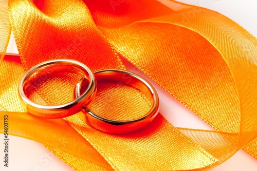 Photo: gold wedding rings on orange ribbon gold wedding rings on orange ribbon