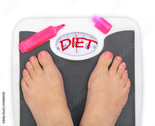 Photo: Woman' s feet on bathroom scale Woman' s feet on bathroom scale
