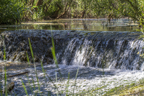Photo: Close view of a small waterfall on a small stream of water. Close view of a small waterfall on a small stream of water.