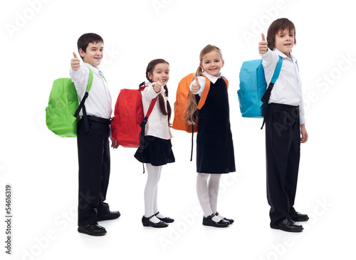Photo: Back to school concept with happy kids giving thumbs up sign Back to school concept with happy kids giving thumbs up sign