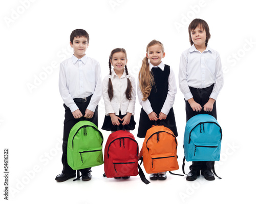 Photo: Group of happy kids with schoolbags - back to school concept Group of happy kids with schoolbags - back to school concept