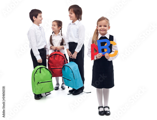 Photo: Back to school concept with a group of kids talking Back to school concept with a group of kids talking