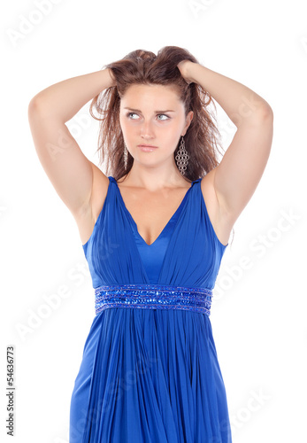 Photo: Portrait of a beautiful young woman in blue dress, holding on to Portrait of a beautiful young woman in blue dress, holding on to