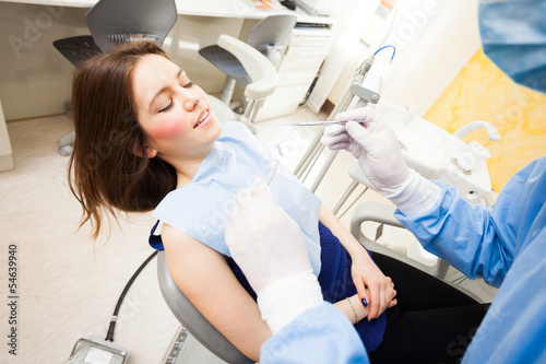 Photo: Dentist doing a dental treatment Dentist doing a dental treatment
