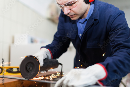 Photo: Worker using a grinder Worker using a grinder