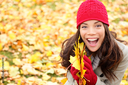 Photo: Asian Autumn woman holding fall leaves in forest Asian Autumn woman holding fall leaves in forest