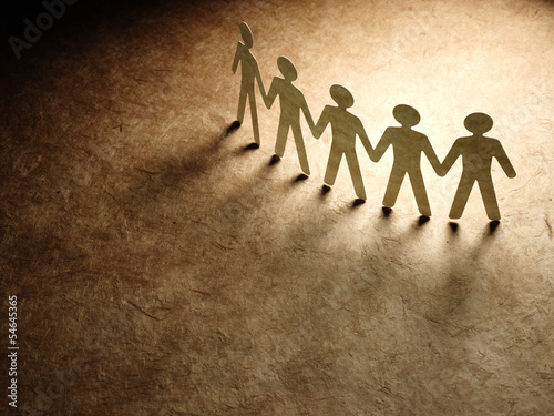 Photo: Group of paper people holding hands. Group of paper people holding hands.